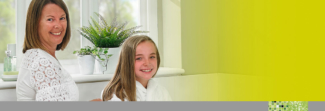 woman and girl smiling in bathroom