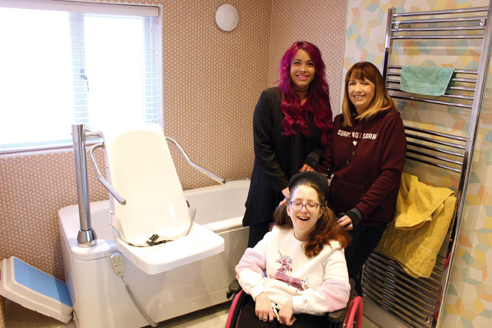 disabled girl and carers in assisted bathroom