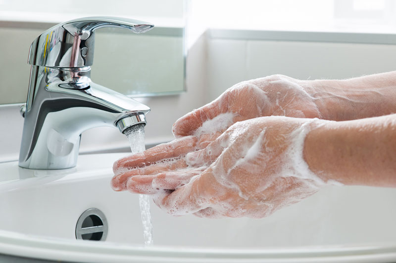 washing hands in sink