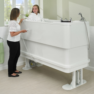 Girl bathing in raised Gemini 1700 powered dual lift platform bath