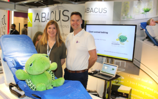 Abacus sales team with toy turtle at Kidz South exhibition