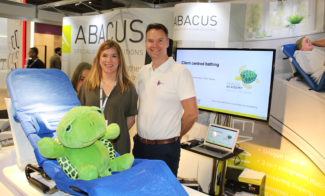 Abacus sales team with toy turtle at Kidz South exhibition